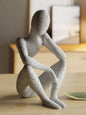 ESTATUA MULHER SENTADA ALÉM DA VISÃO